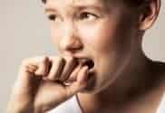 Young woman, hand to mouth, close-up